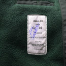 Close-up of green fleece police jacket lining with WAHLER label, size 36, 100% polyester micro fabric inner tag.