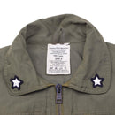 Close-up of olive genuine Italian army coverall flight suit collar with star patches and zipper closure