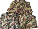 Three folded genuine Romanian Army M93 camouflage parkas in combat leaf pattern on white background