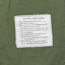 Close-up of inner label on Mil-Tec US Military style OD M64 Vietnam jungle jacket detailing care and features.
