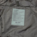 Close-up of MIL-TEC wet weather tactical jacket interior label showing care instructions and material details