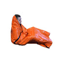 Person wrapped in an orange emergency blanket on a white background