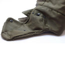 Close-up of olive green Austrian military winter cap ear flap with snap buttons and soft lining detail.