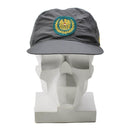 Genuine Austrian military gray GoreTex cap with foldable earflaps and embroidered emblem on front, displayed on white mannequin.