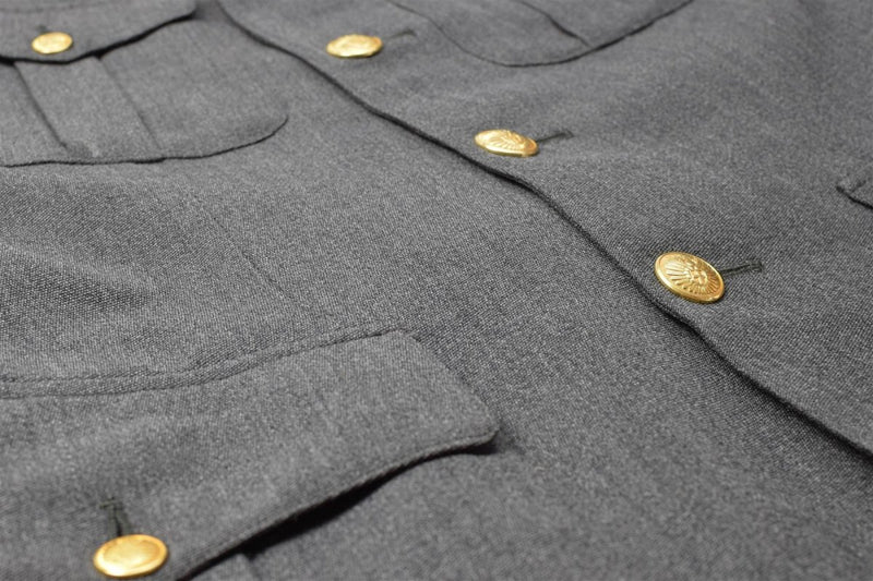 Close-up of Danish Civil Defence Forces gray military uniform jacket with gold buttons and pocket details
