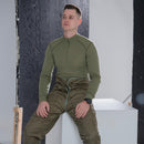 Man wearing olive green Dutch Military thermal underwear shirt with high neck and long sleeves sitting indoors