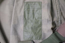 Close-up of label inside French army combat pants made from durable ripstop fabric with care instructions.