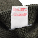 Care label on olive green French army pullover showing wool and chlorofibres blend composition and care symbols
