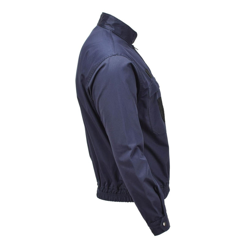 Side view of navy blue French military police tactical jacket with elastic waistband and adjustable cuffs