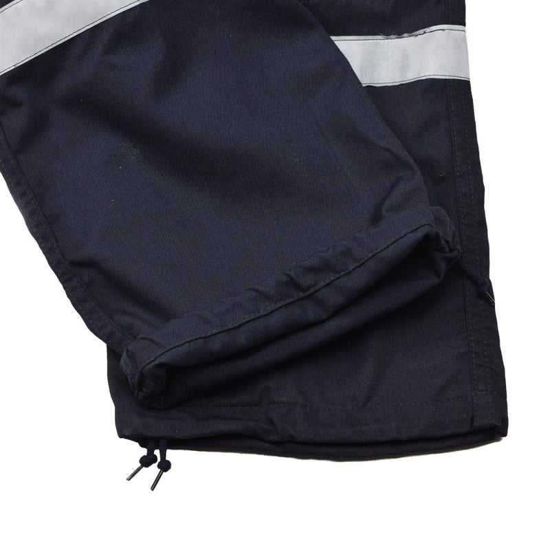 Close-up of dark blue French navy marine jumpsuit leg with reflective bands and adjustable drawstring hem.