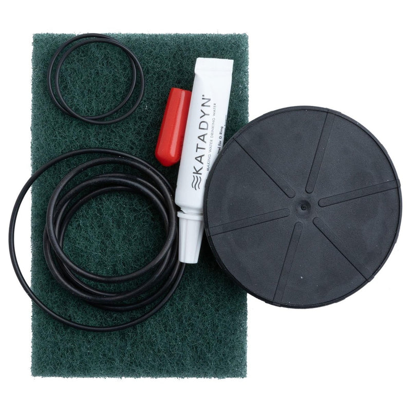 Katadyn Vario water filter maintenance kit with spare O-rings, cleaning pad, lubricant, and outlet cover parts.
