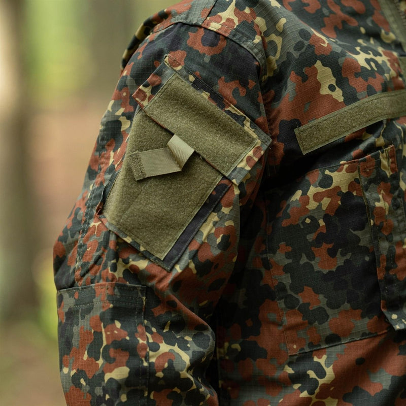 Close-up of MFH Brand U.S. Military style jacket in flecktarn camo ripstop with arm pocket and hook and loop patch panel