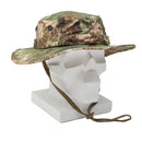 Camouflage MIL-TEC army boonie hat with wide brim, adjustable chin strap, and waterproof laminate fabric displayed on mannequin.