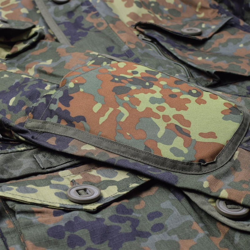 Close-up of Mil-Tec Flecktarn camo RipStop smock with multiple pockets and durable polycotton fabric detail.