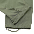 Close-up of olive drab Mil-Tec U.S. Army M64 Vietnam jungle style combat pants adjustable cuffs and drawstrings.