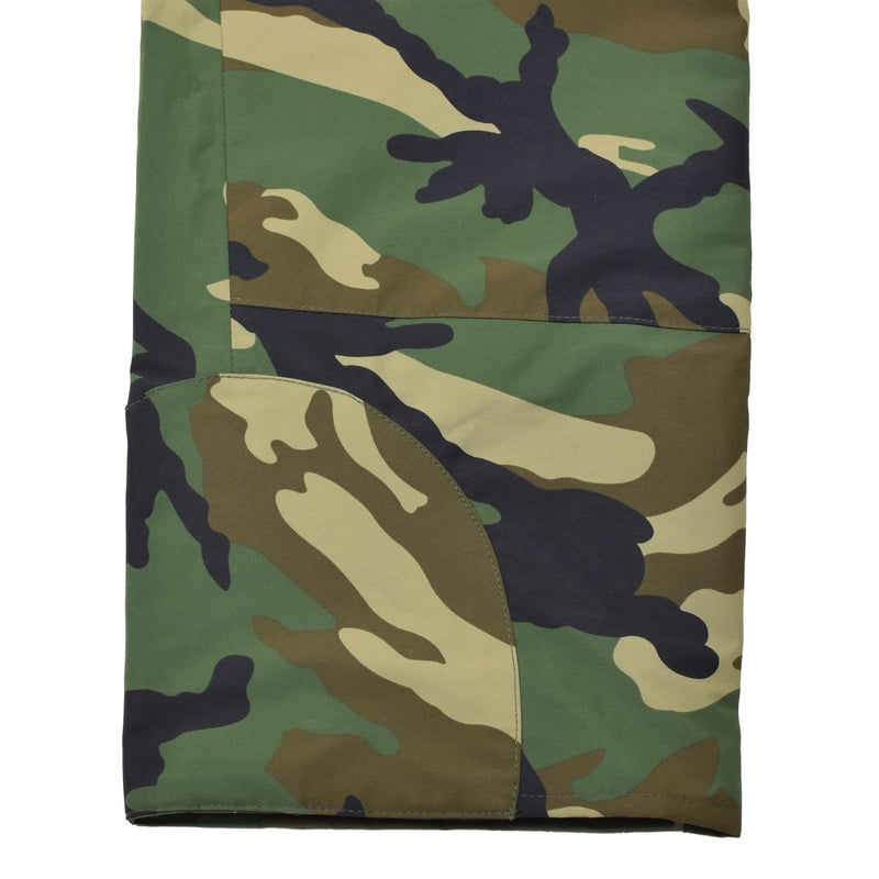 Close-up of camo MIL-TEC military style cold weather pants showing waterproof and windproof fabric details.