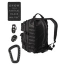 Black MIL-TEC U.S. Assault tactical backpack with patches, grenade, skull accessory, and carabiner for hiking and camping.