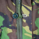Close-up of a woodland camo British army BDU combat smock jacket with zipper and button storm flap detail