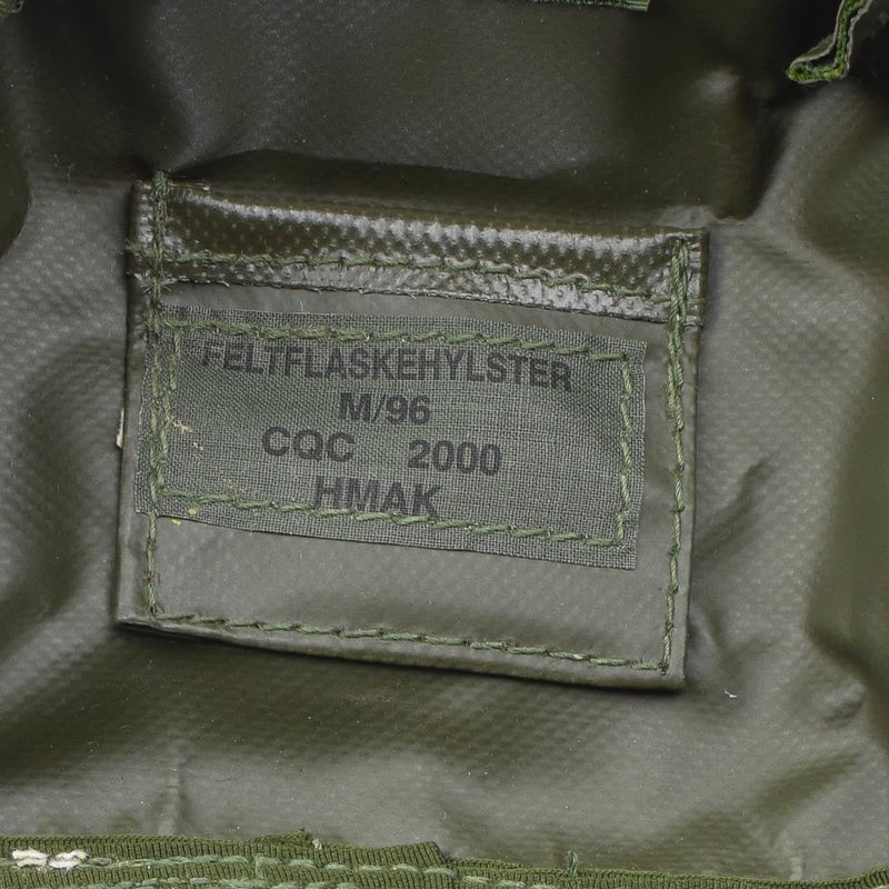 Close-up of label inside an original Danish military flask pouch with M84 camouflage and model information.