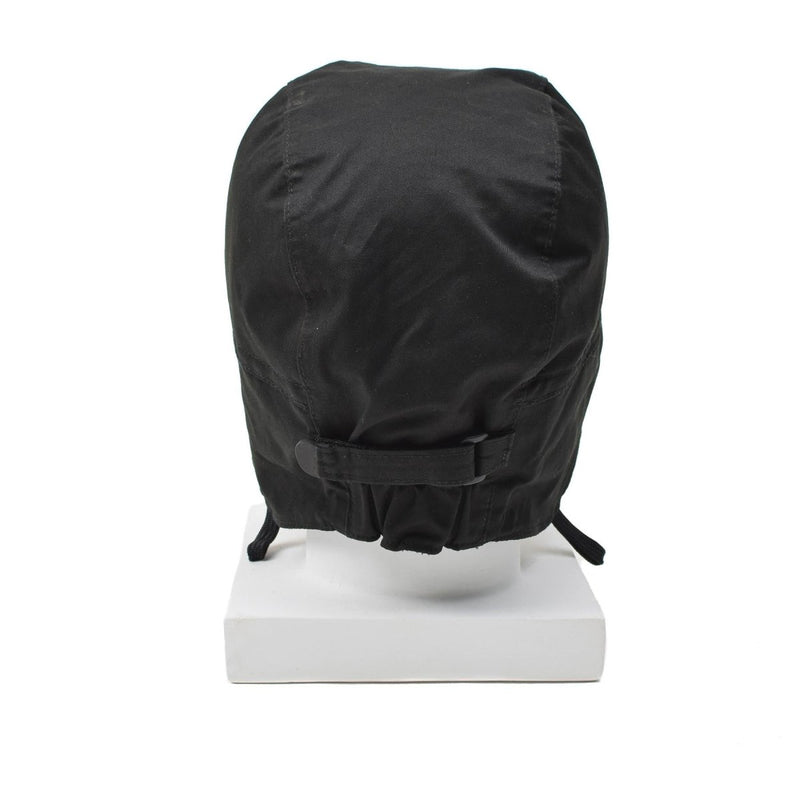 Black Dutch paratrooper hat with adjustable strap, ear flaps, and windproof design displayed on white stand