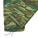 Close-up of genuine Greek army BDU pants in lizard camouflage with adjustable ankle drawstrings and reinforced fabric.