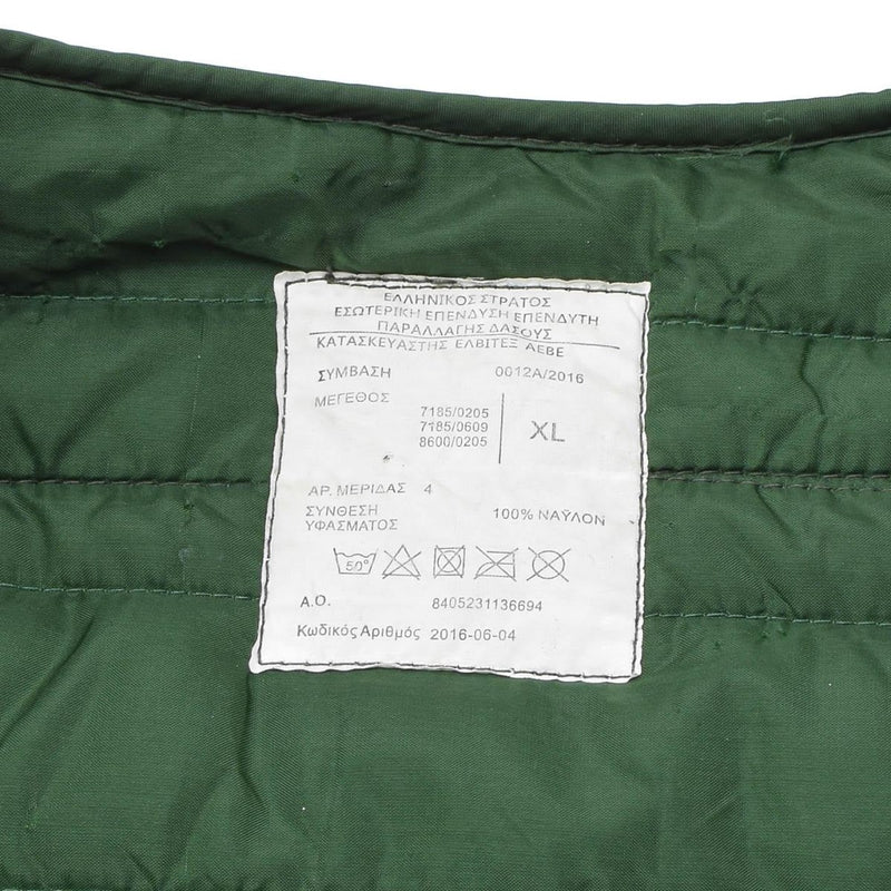 Close-up of size XL white label with Greek text and care symbols on green Original Greek military M65 liner jacket