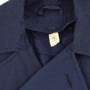 Close-up of vintage original Italian military trenchcoat in khaki blue waterproof raincoat fabric showing collar and label.
