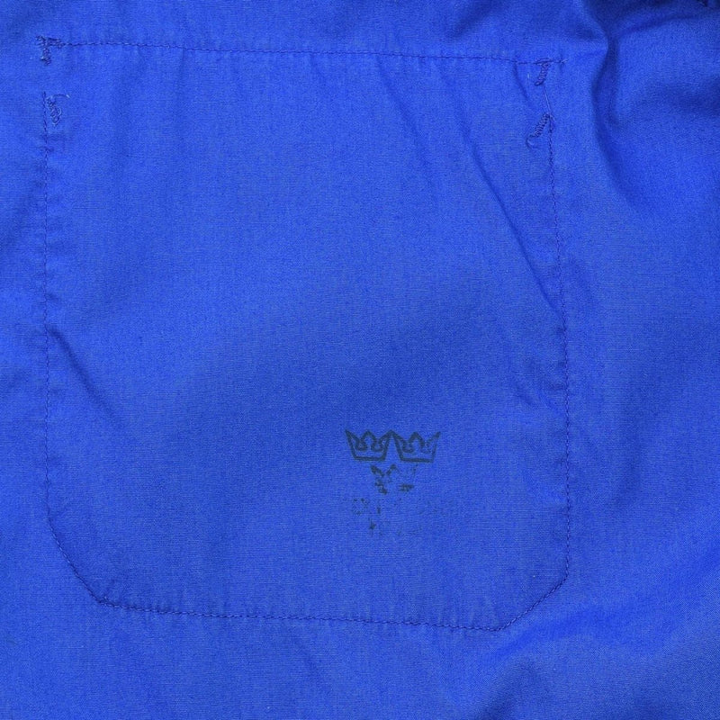 Close-up of the original Swedish Military sports jacket blue retro tracksuit pocket with faded emblem detail.