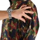 Close-up of hand opening zippered pocket on original Swiss army Alpenflage camouflage coverall suit sleeve