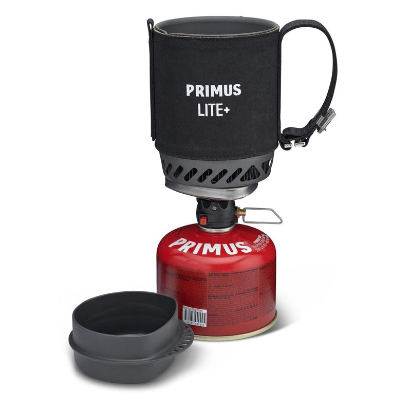 Primus Lite Plus lightweight camping stove with ceramic coated pot, fuel canister, and compact cooking bowl set for hiking.