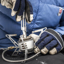 Person wearing gloves assembling the Primus OmniFuel II Multifuel camping stove outdoors on a black surface