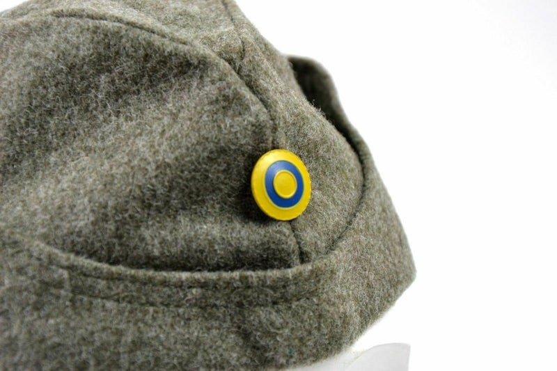 Close-up of WWII Swedish army winter wool side cap with blue and yellow roundel button on side
